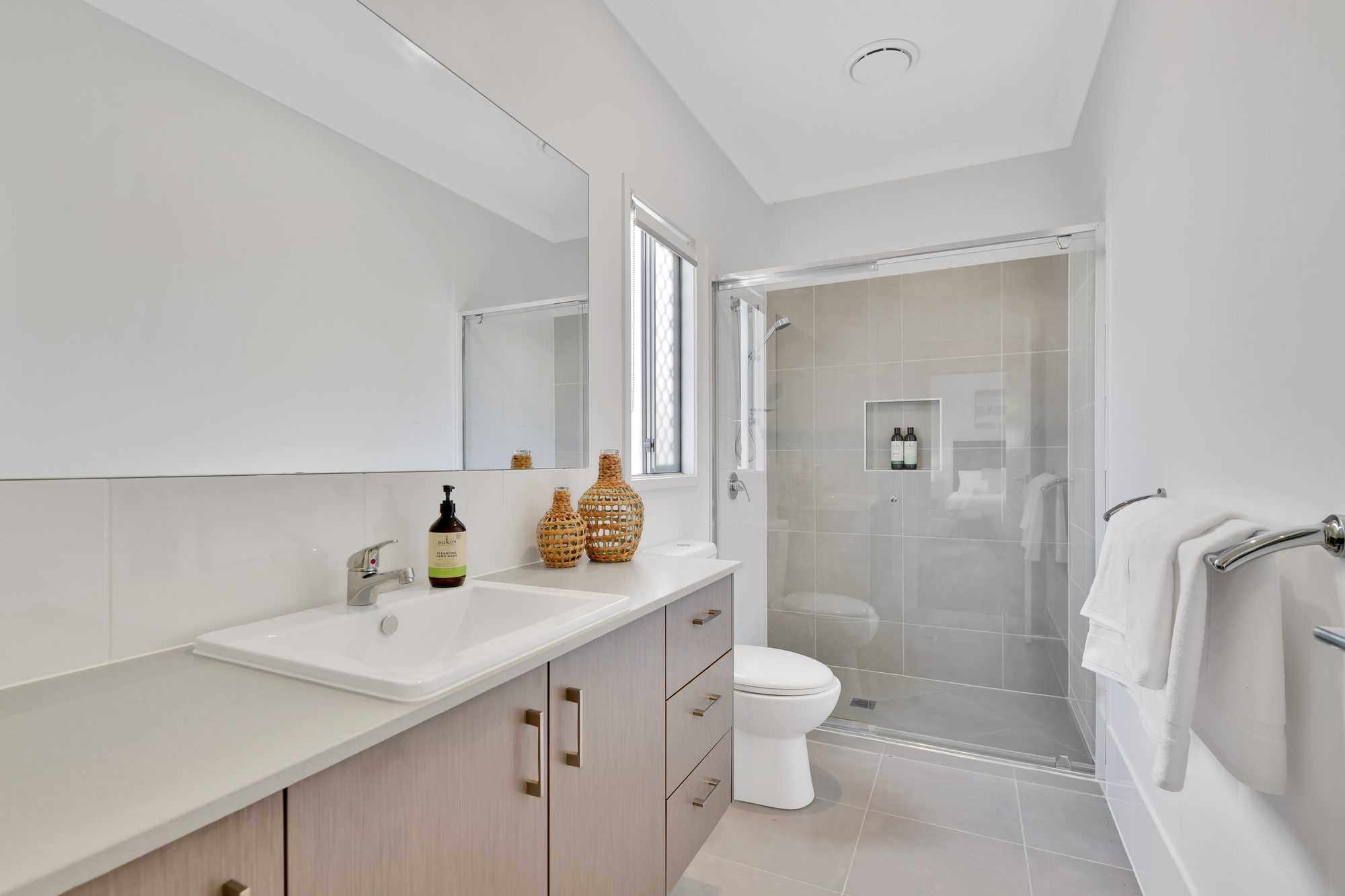 Modern bathroom with walk-in shower, vanity and quality finishes