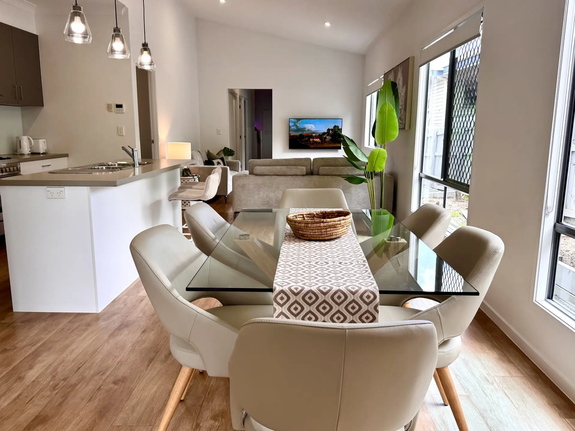 Light-filled dining area and open-plan living with garden views