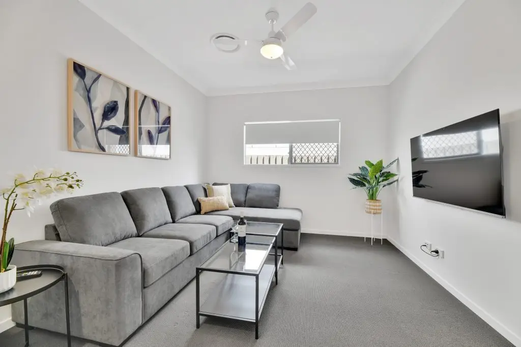 Separate media room with 65-inch Smart TV and modular lounge