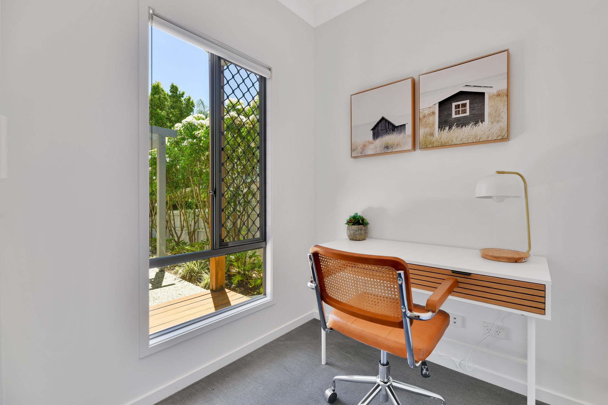 Dedicated study nook with desk and leafy garden outlook