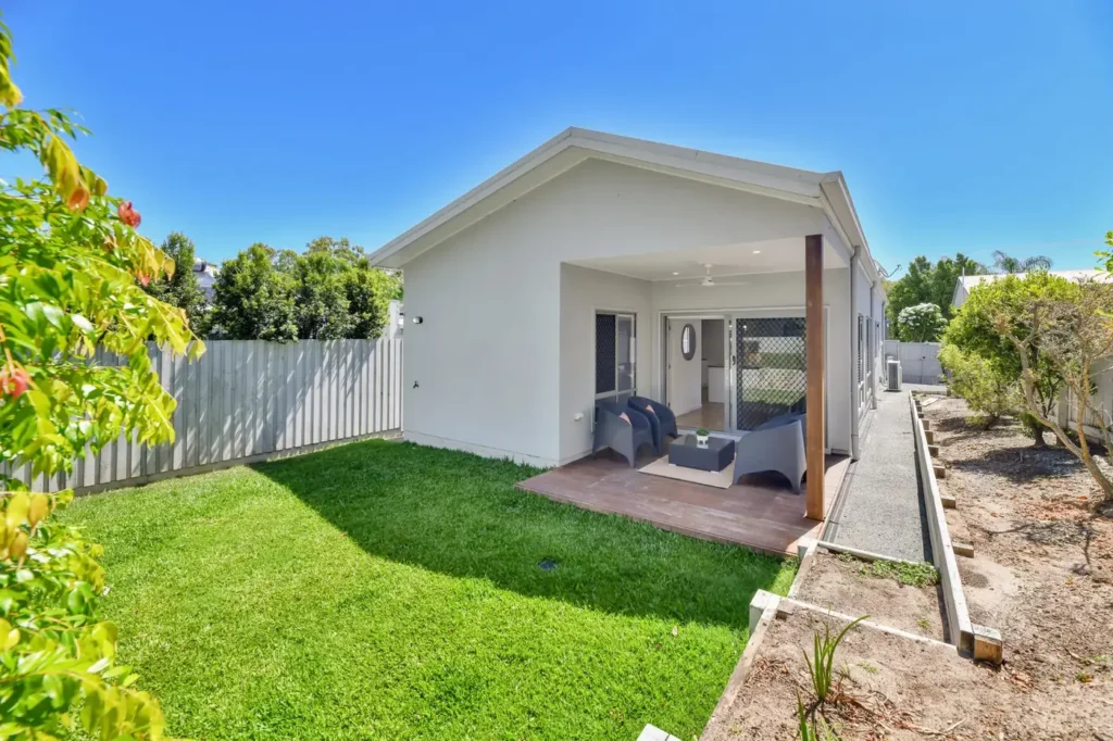 Fenced back lawn with the covered deck at the rear of the house