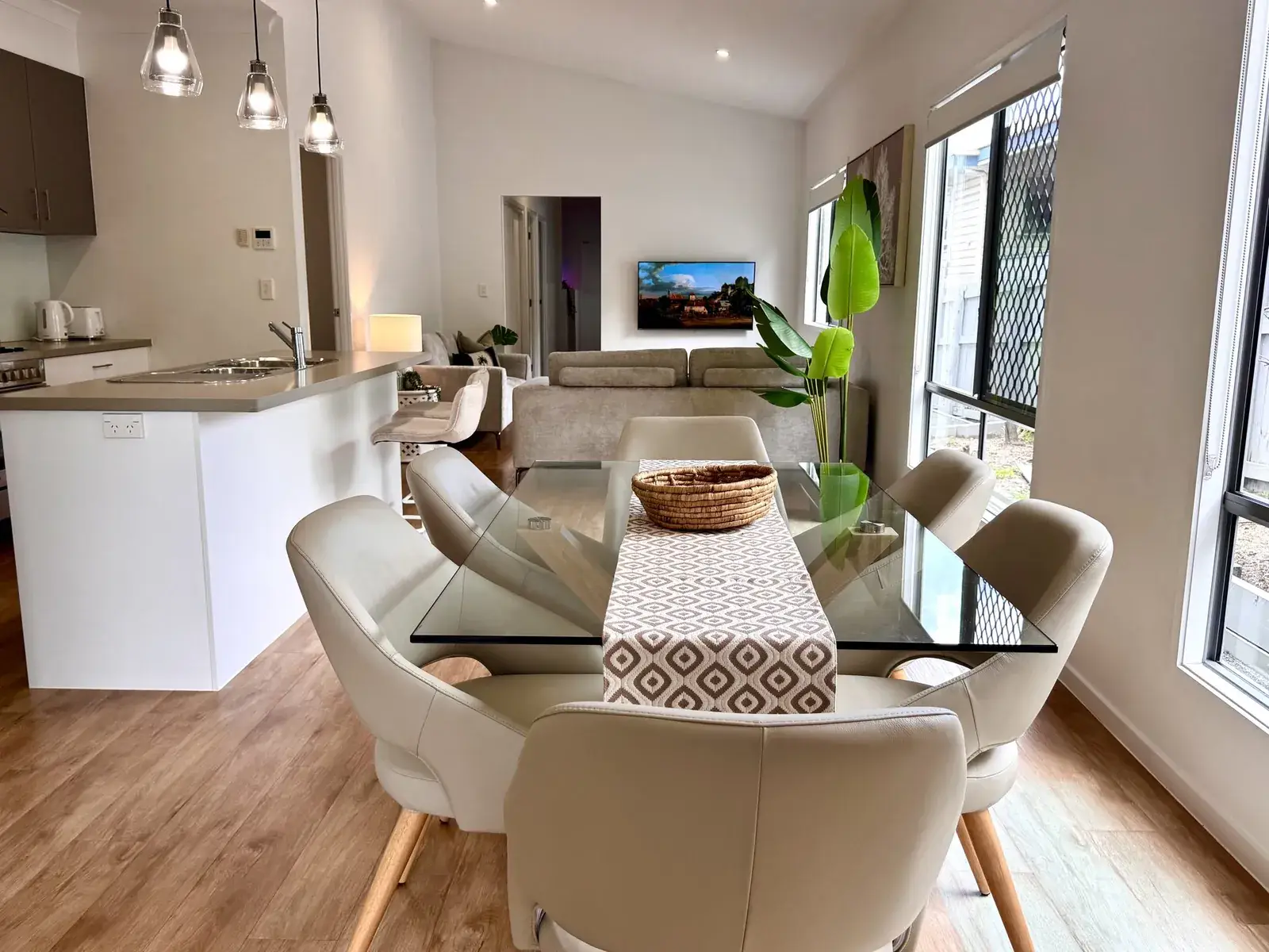 Light-filled dining area and open-plan living with garden views