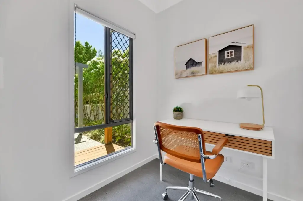 Dedicated study nook with desk and leafy garden outlook